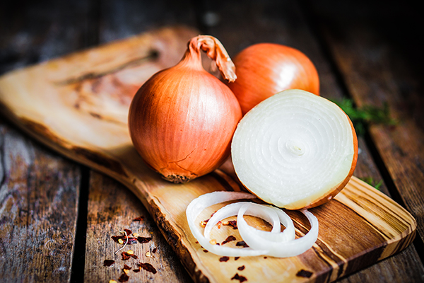 Onions on rustic wooden background