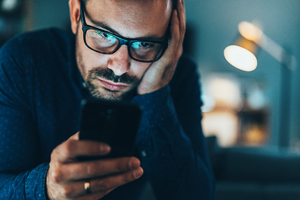 Man scrolling through smartphone