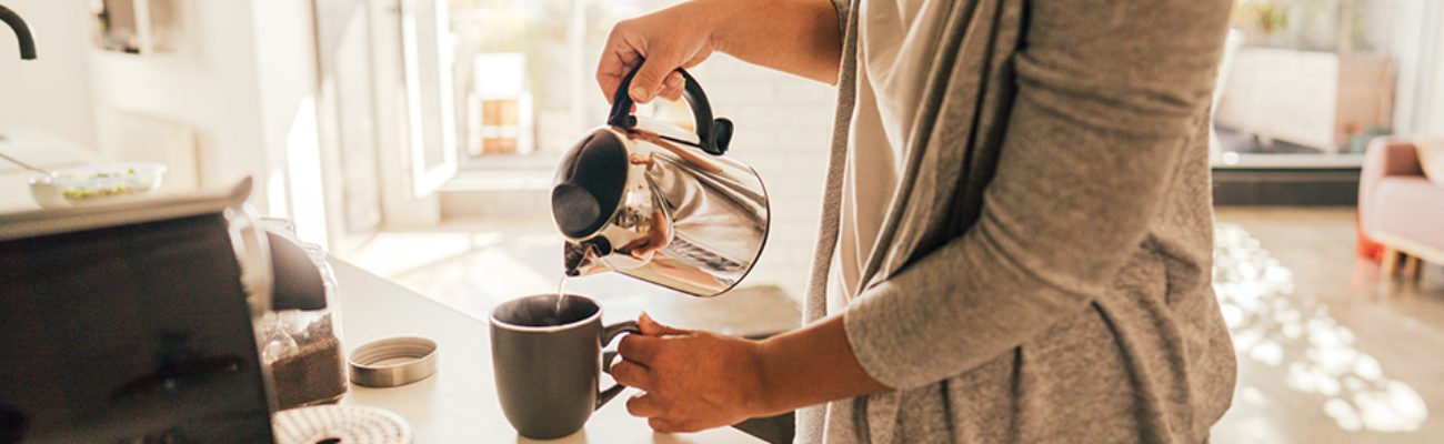 Woman making tea in her kitchen