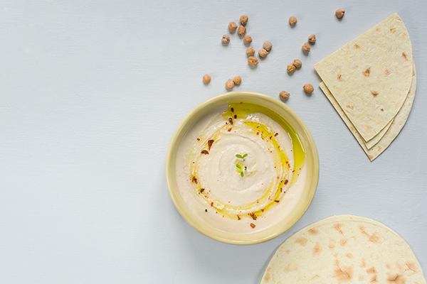 Bowl of hummus and tortillas