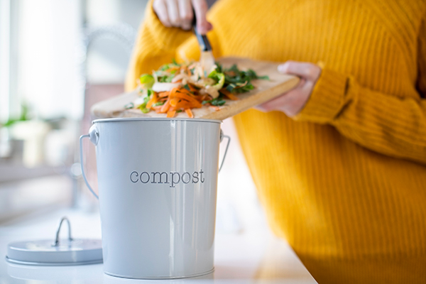 Woman Making Compost From Vegetable Scraps