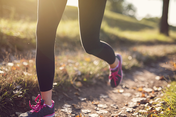 Woman running on a trail outside