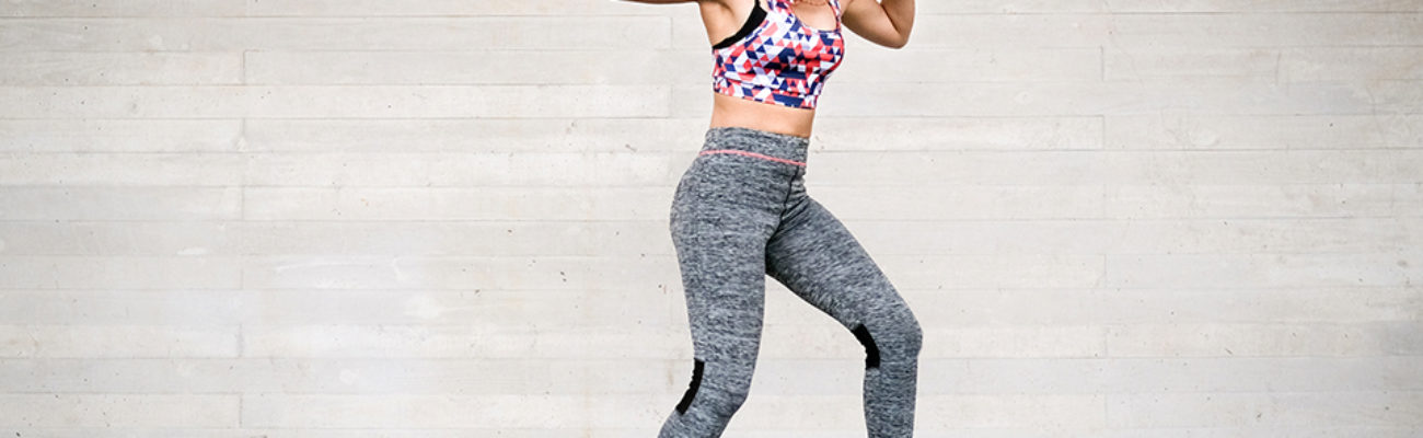 Young woman dancing with headphones and smartphone