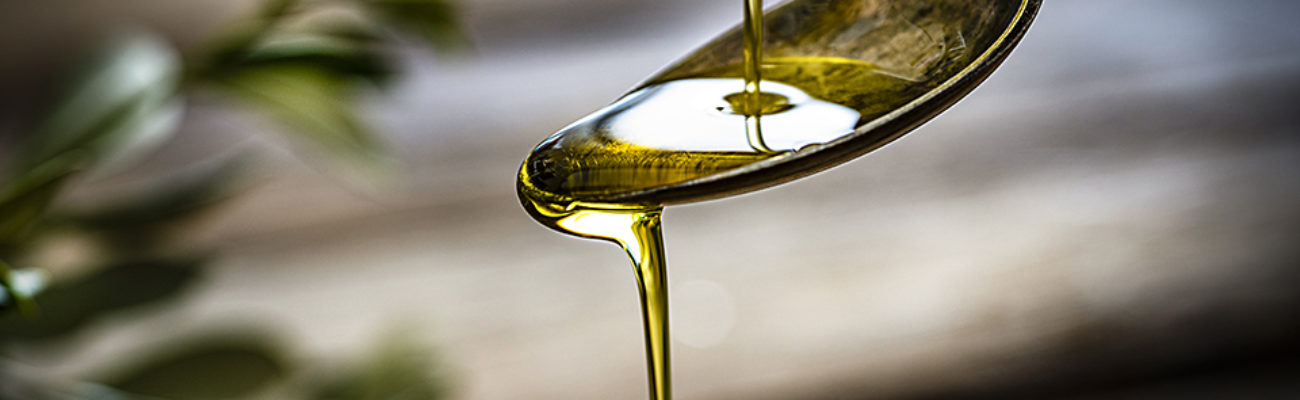 Pouring olive oil onto a spoon