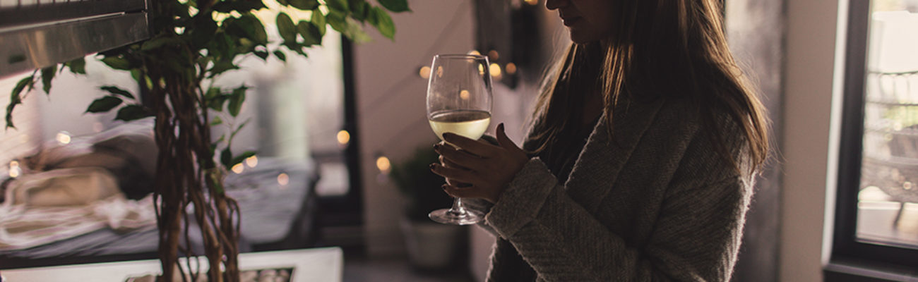 Woman drinking a glass of wine at home