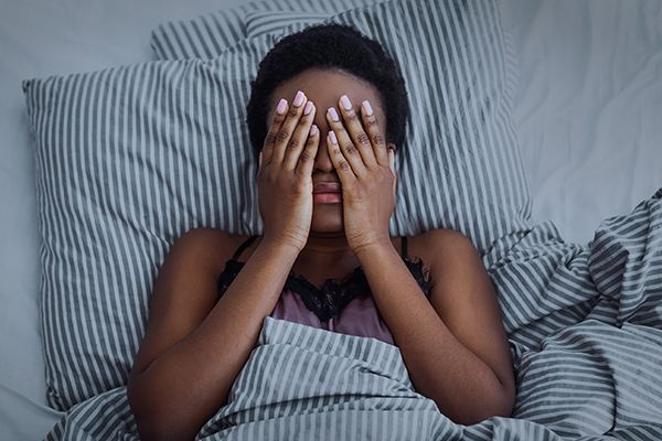 Woman in bed unable to sleep