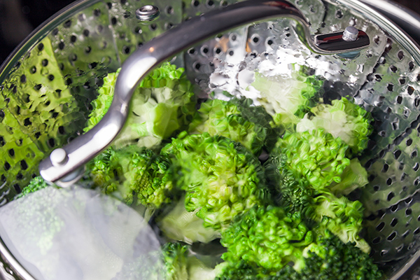 Freshly steamed green broccoli in pot.