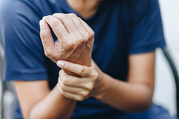 Person holding their own wrist