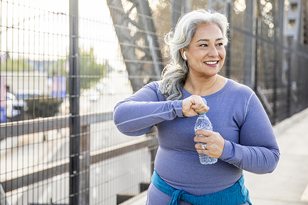 Woman drinking water after a workout.