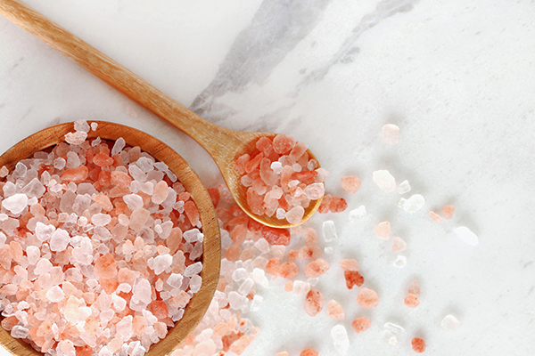 Top view of himalayan pink rock salt in wooden bowl 