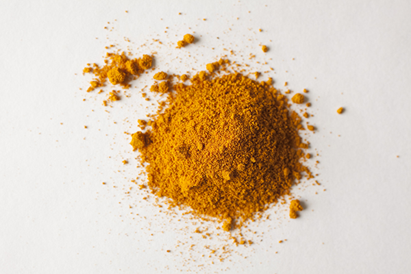 A pile of turmeric shot on white