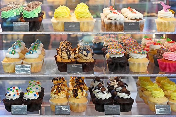 Bakery window with variety of cupcakes.