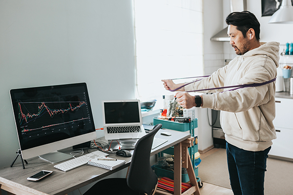 Man stretching while working from home