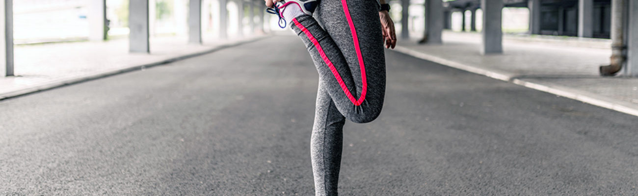 Woman stretching her legs before a run