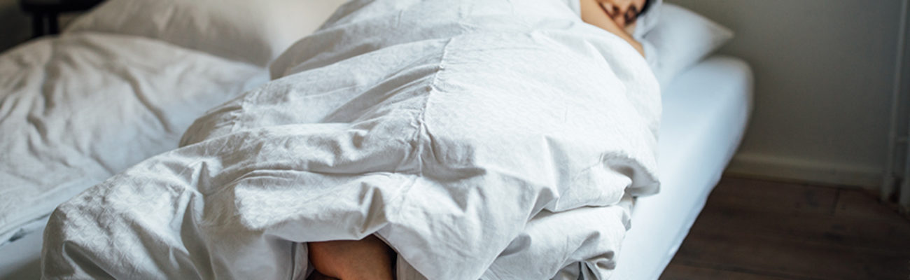 Woman sleeping under weighted blanket