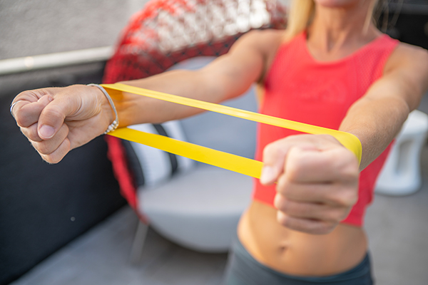 Woman exercising at home with resistance band