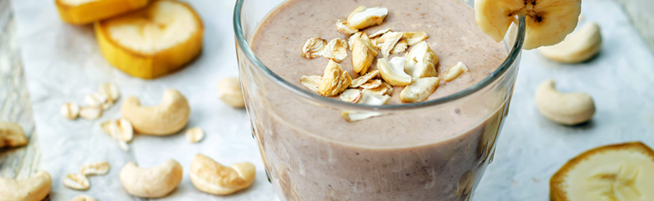 Shakeology cashew banana cocoa smoothie in a glass