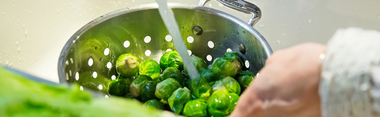 Rinsing Brussels sprouts in colander