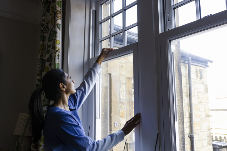 Woman Closing Windows | Spring Allergies