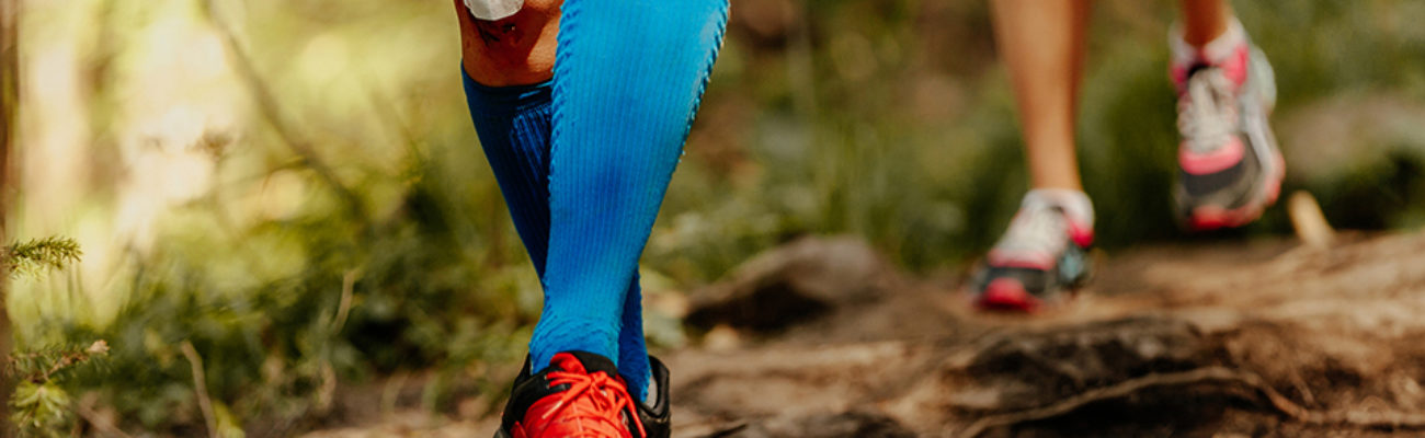 Female runner wearing blue compression socks