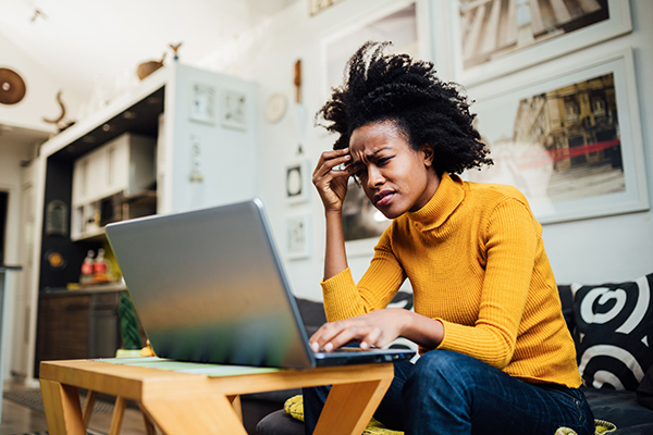 Stressed out woman looking at her computer