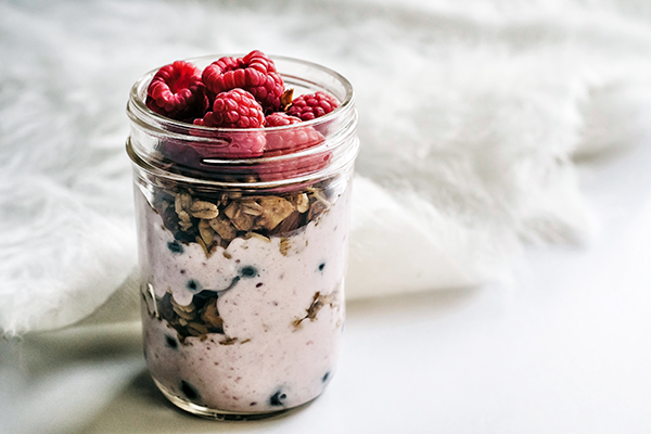 Overnight oats in glass jar with berries on top