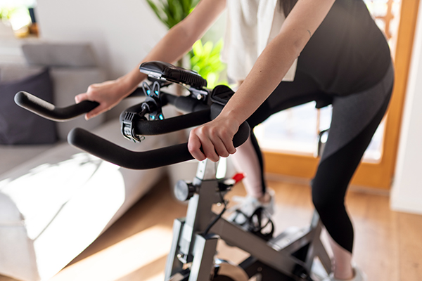 Woman exercising at home on indoor bike