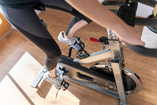 Woman exercising at home on indoor bike
