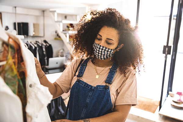 Woman shopping with mask on, post pandemic