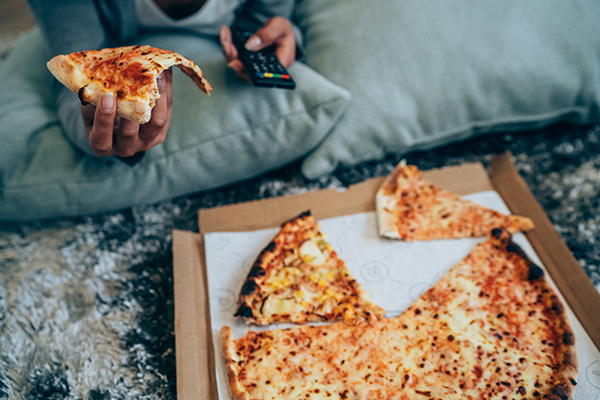 Woman eating a pizza at home