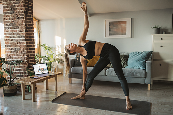 Woman at home doing online workout