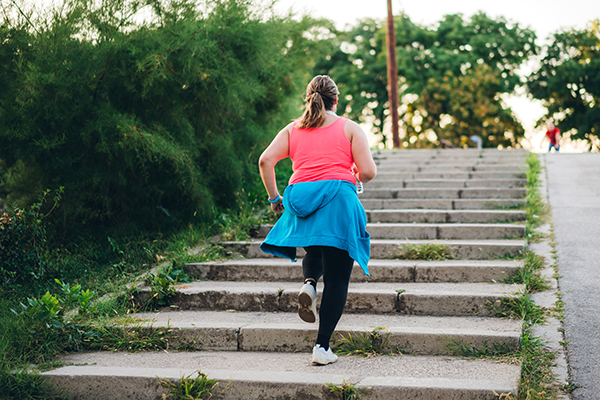 Woman outside running up steps