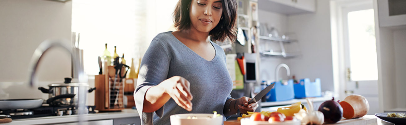 Woman chopping vegetables in kitchen