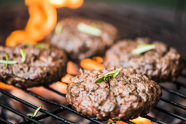 Burgers cooking on a grill