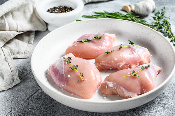 Raw chicken thighs with seasoning