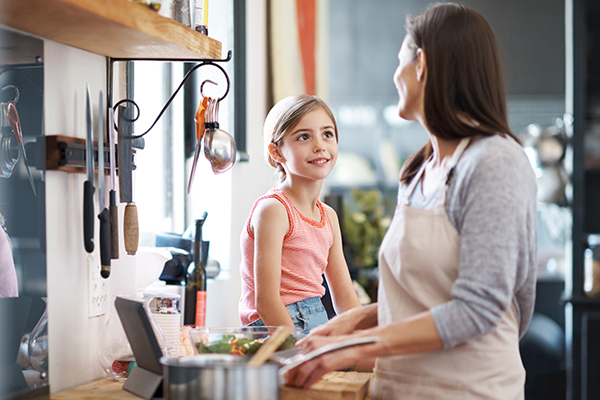 Mom and daughter cooking at home together