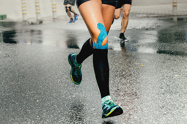 Cropped shot of runner with KT tape on knee