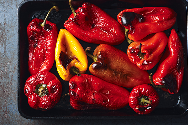 Roasted red and yellow bell peppers in baking tray 