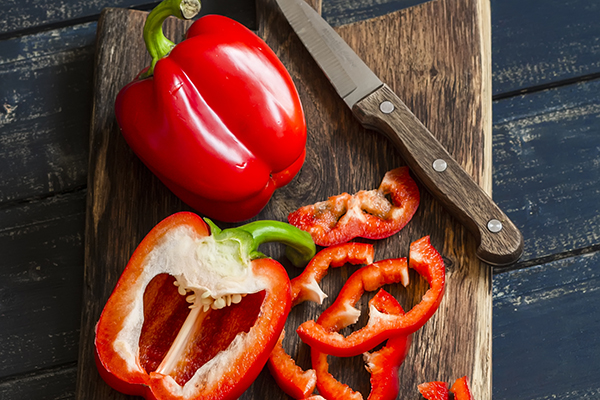 Fresh red sweet pepper on a wooden board