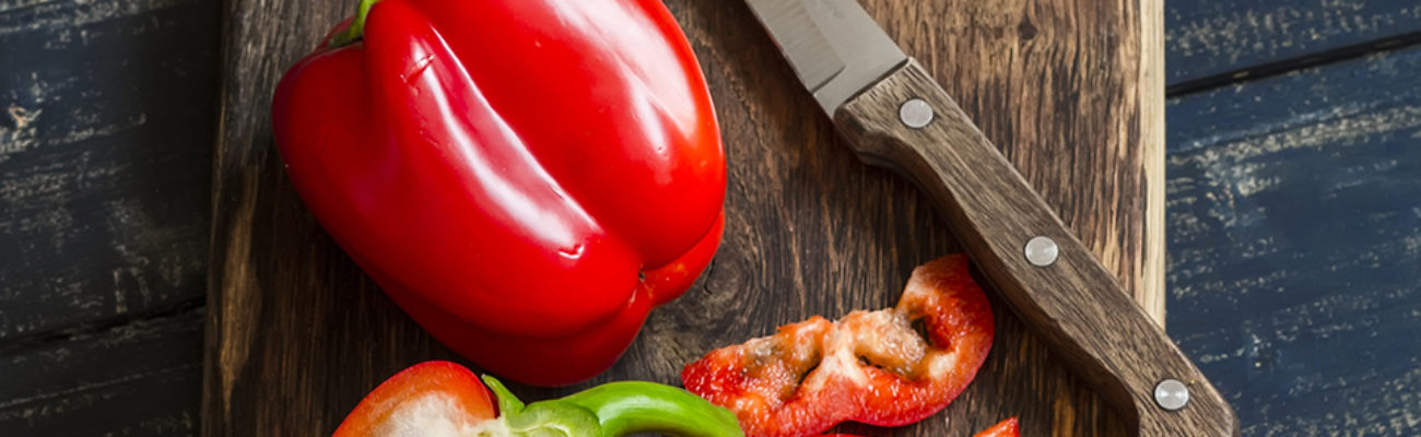 Fresh red sweet pepper on a wooden board