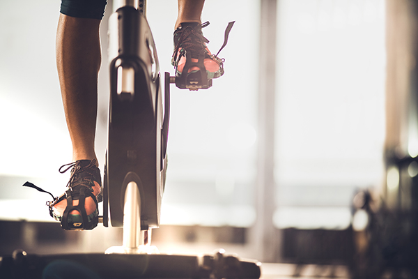 Cropped shot of person's feet on indoor bike pedals