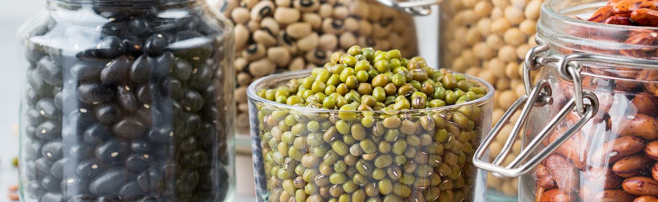 Different types of beans in glass jars