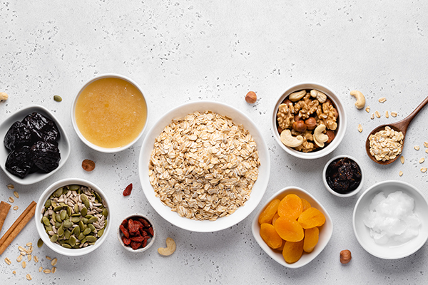 Healthy granola ingredients in small bowls