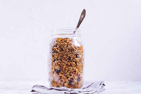 Delicious homemade granola in glass jar snack.