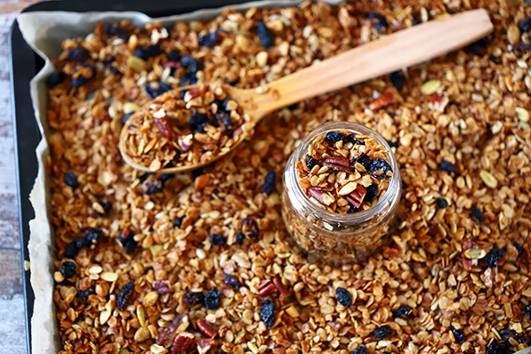 Homemade granola in a jar and on a baking pan.