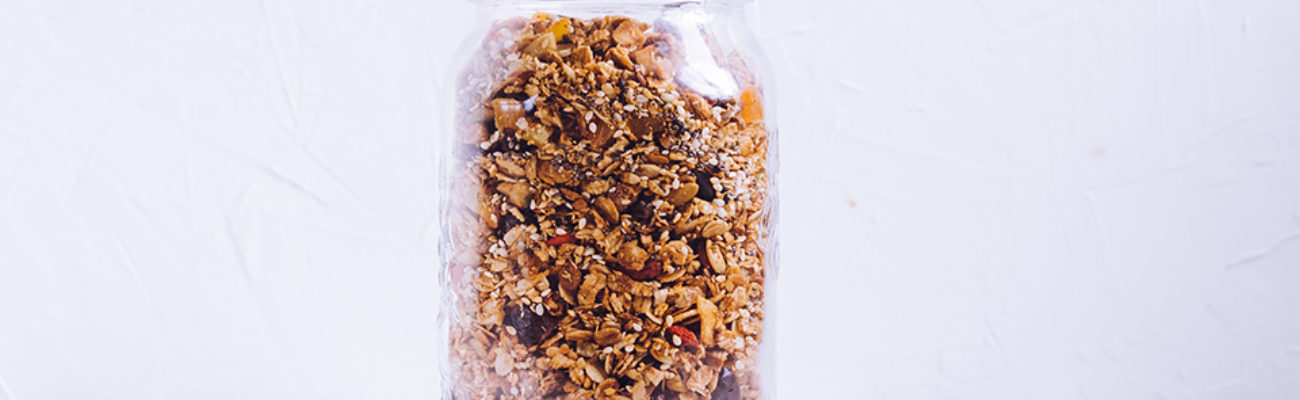 Delicious homemade granola in glass jar snack.