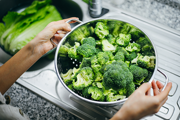 Raw broccoli in a colander