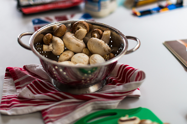 Raw mushrooms in a colandar