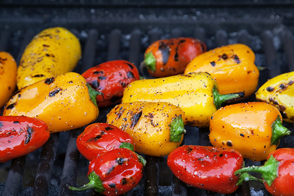 Colorful little roasted peppers on the grill.