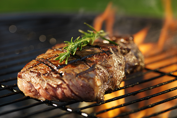 Steak cooking on grill